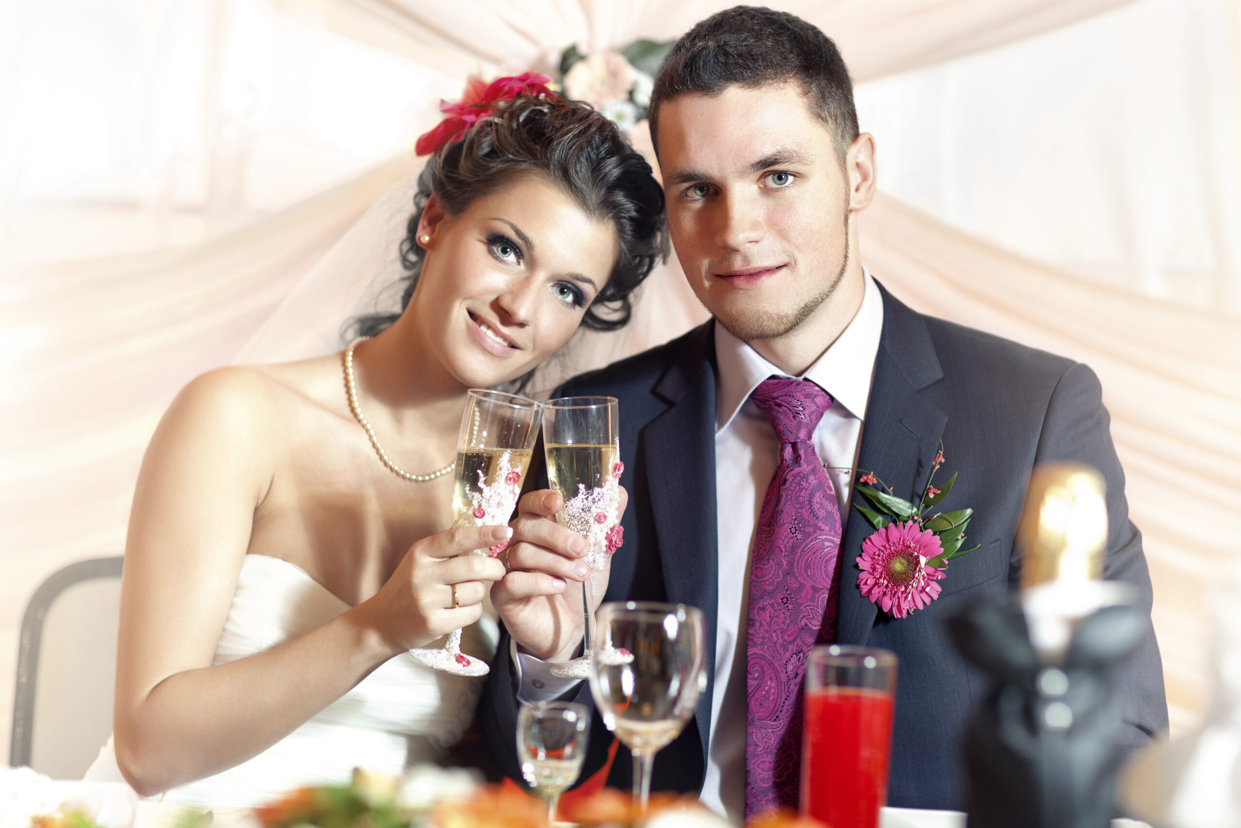 Bride and groom toasting at reception table